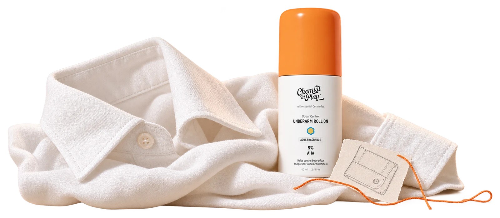 The actual orange-cap Chemist at Play roll-on beside the shoulder of a folded white cotton shirt.