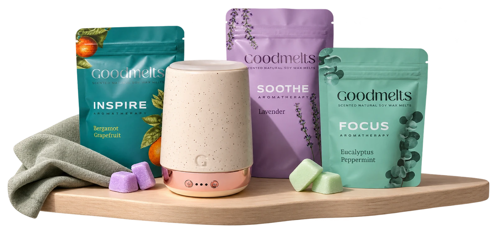 The actual Goodmelts warmer and wax-melt pouches in a small tabletop corner with a few wax cubes.