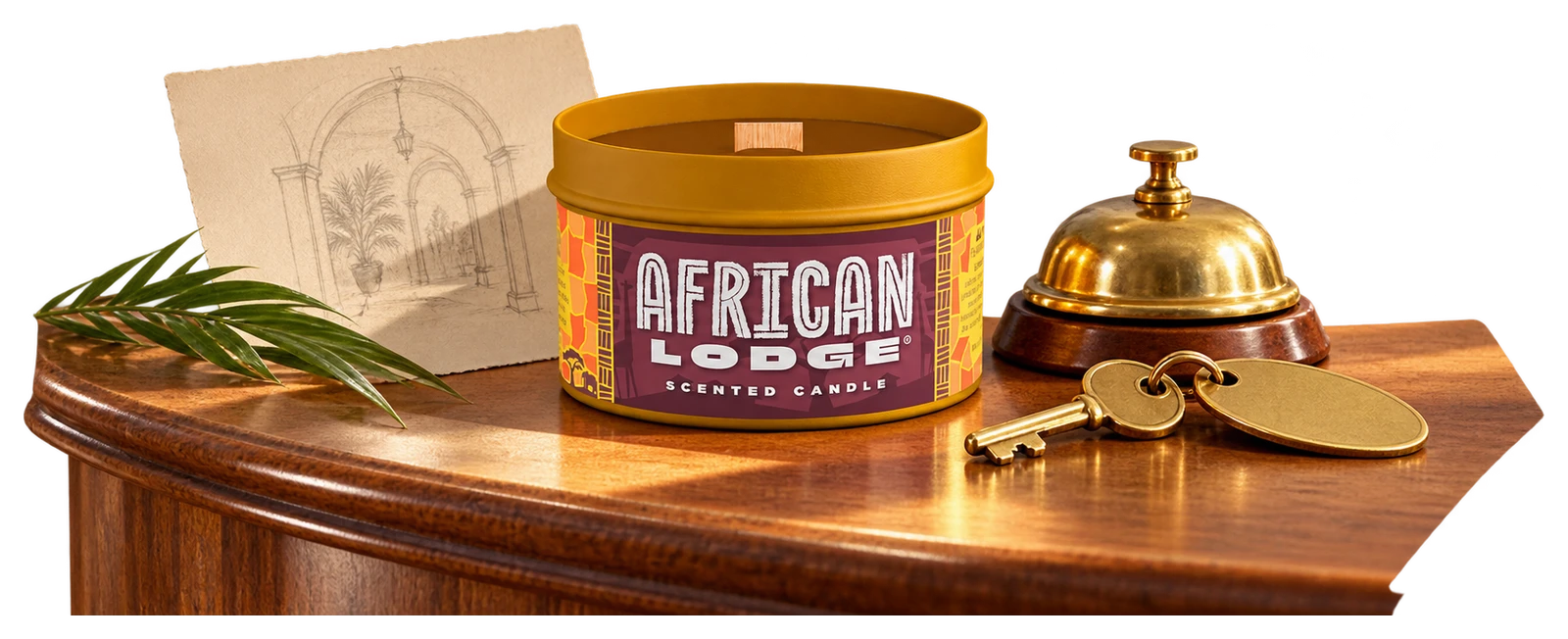 The actual African Lodge candle beside a plain brass hotel key and a small desk bell.