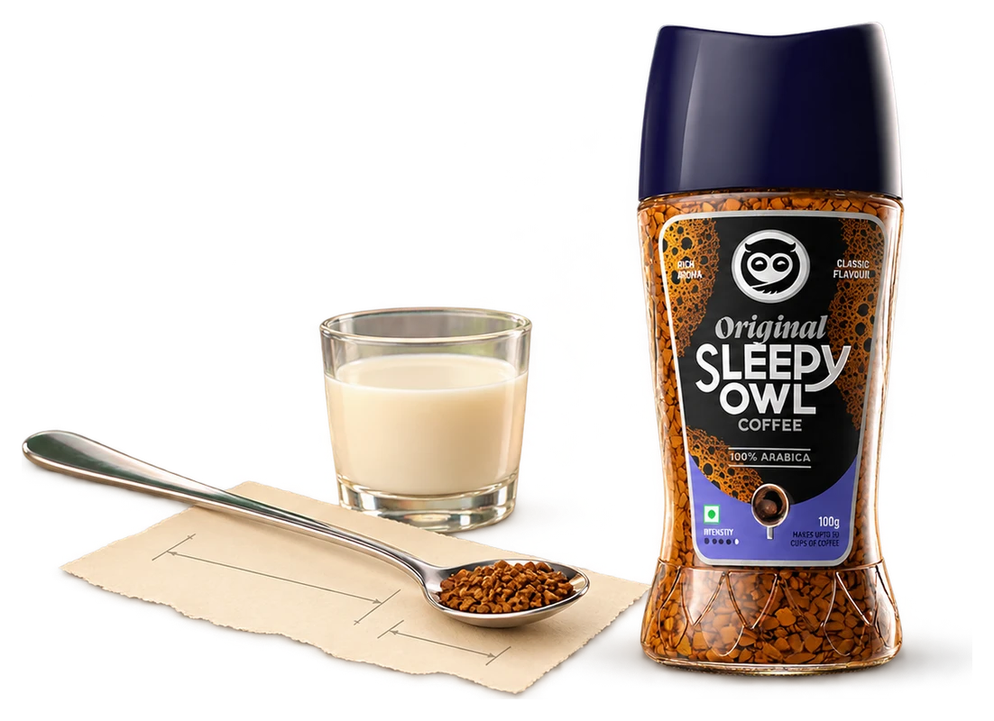 An actual Sleepy Owl instant-coffee jar beside an ordinary long teaspoon with faint blueprint marks.